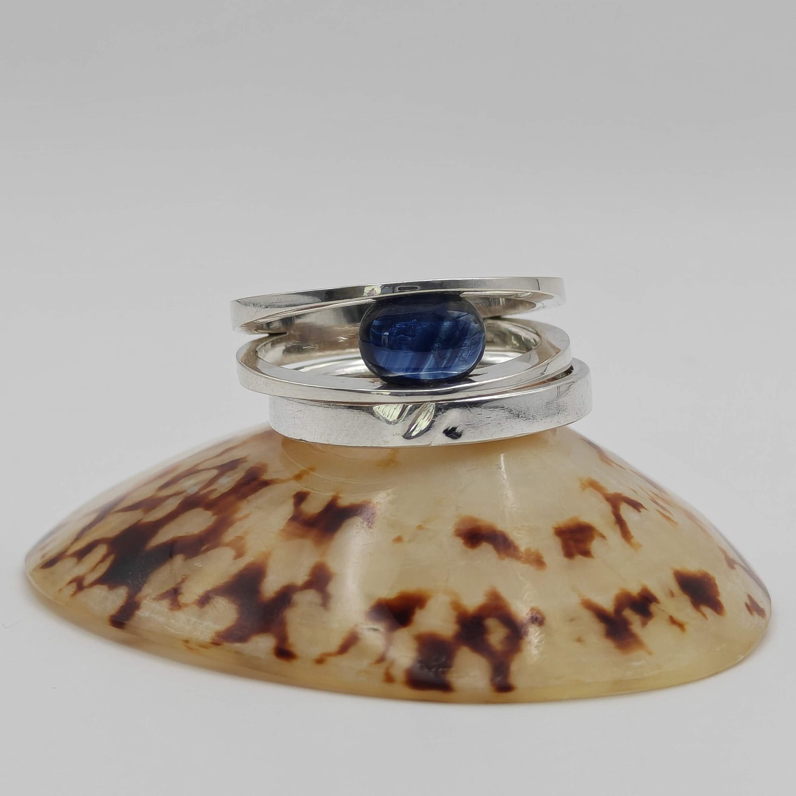 Sterling silver and sapphire tension ring where the stone holds the structure